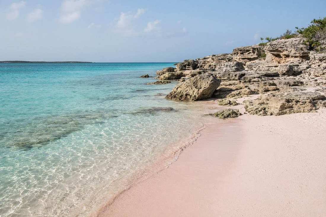 Pink sand and clear shallow water on an empty Bermuda beach