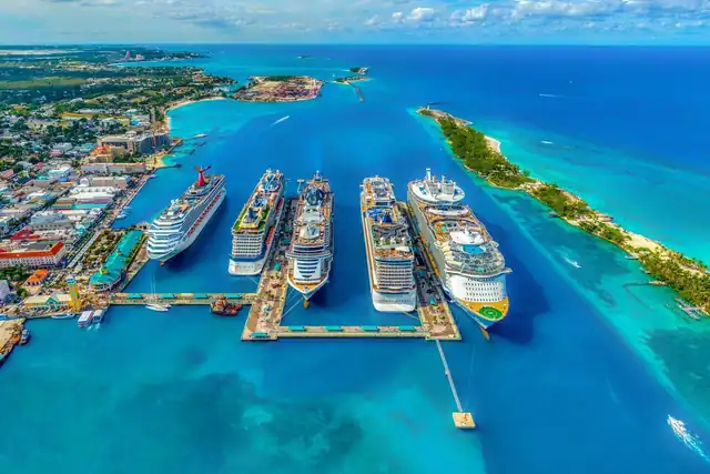 Cruise ships docked along a pier in turquoise water