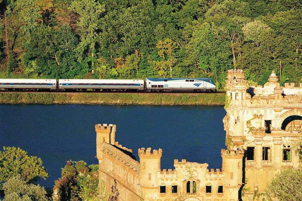 An Amtrak train along the Hudson, with Bannerman Castle in the foreground