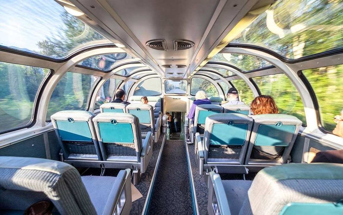 Seats under the curved glass of a dome car