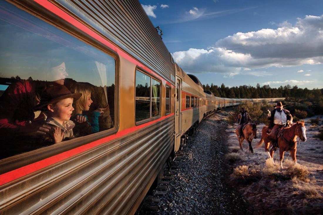 Grand Canyon Railway passenger cars crossing pine country