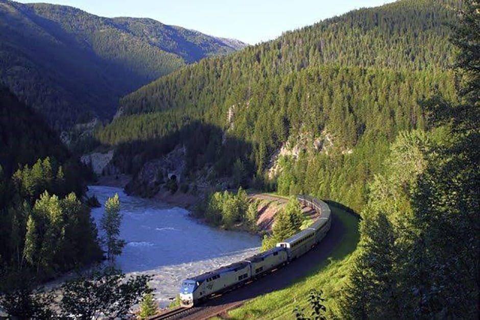 The Empire Builder following a river through forested mountains