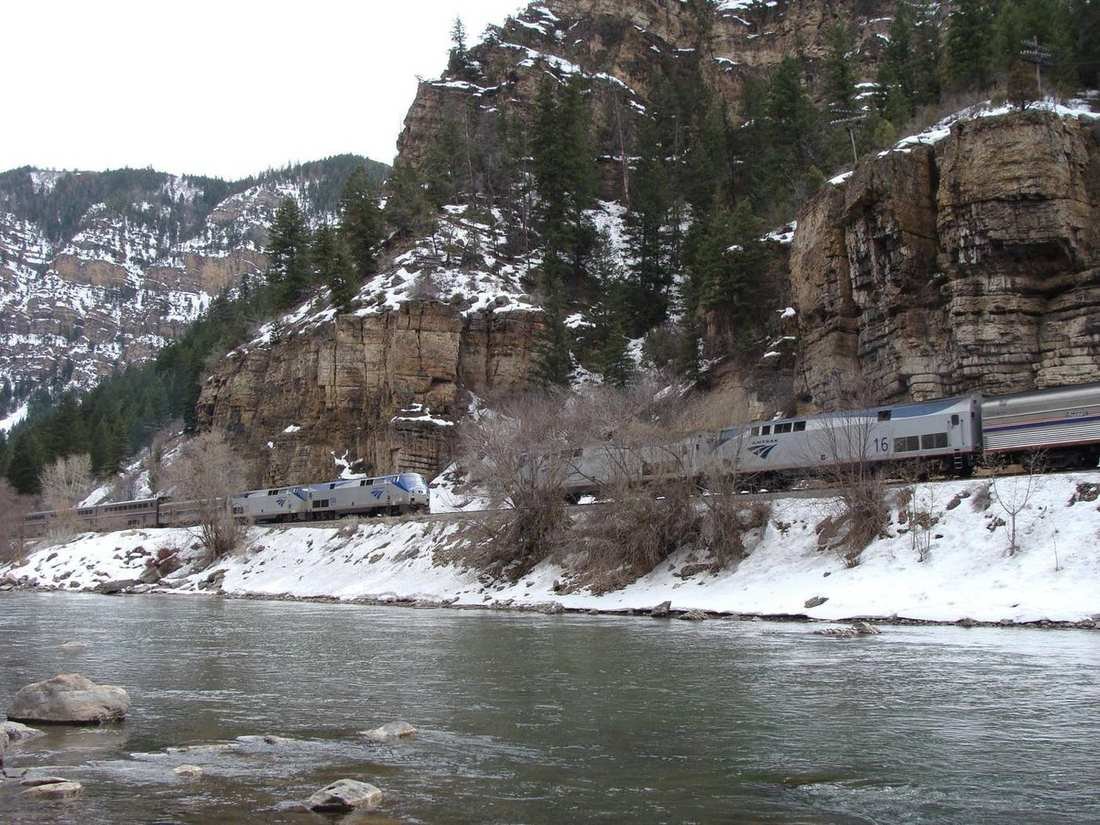 The California Zephyr along the Colorado River under a rock wall