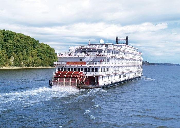 American Heritage, an American Cruise Lines paddlewheeler, on a river
