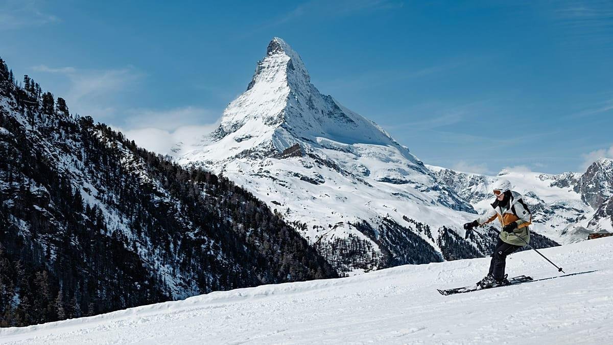 A skier on a slope with the Matterhorn behind